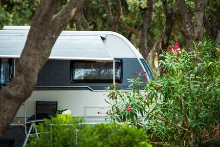 Travel Trailer RV Park Spot with Privacy. Caravaning Theme.