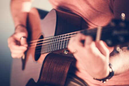 Men with Acoustic Guitar in Hands. Playing Caucasian Musician.