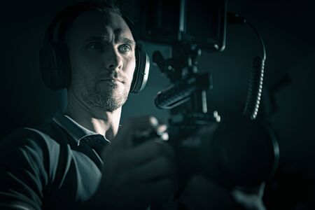 DSLR Rig Videography Film Camera Caucasian Operator with Headphones. Modern Video Creator. 