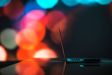 Laptop Computer Work Station Theme with Colorful Bokeh Background and Copy Space. Modern Technology.