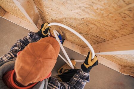 Construction Plumbing Contractor Installing Cold and Hot Water Line in Newly Constructed Bathroom....