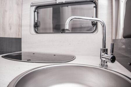 Elegant and Modern RV Motorhome Sink and Faucet. Recreation Vehicle Kitchen Area Interior.の写真素材