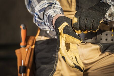Construction Industry Worker Wearing Safety Gloves. Closeup Photo