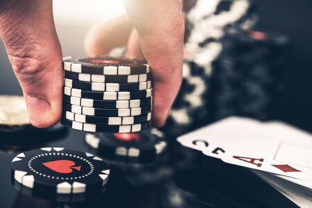 Poker Player Placing Bid Closeup Photo. Gambling Industry Concept with Casino Chips.