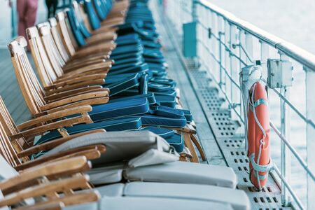 Cruise Ship Oceanliner Travel Risk and Crisis Management. Empty Deckchairs on Main Deck of the Vessel.の写真素材