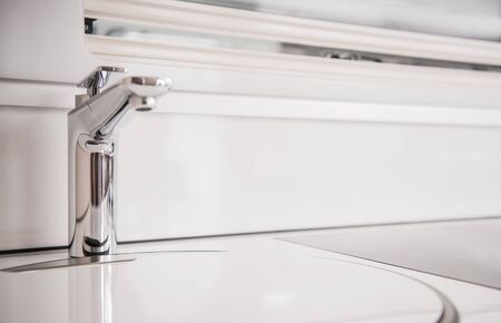 Close Up Of Silver Metal Small Facuet By White Sink Inside Of Recreational Vehicle Camper. 