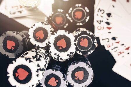 Gambling Industry. Las Vegas Poker Casino Game with Pile of Casino Chips on a Table. Playing Cards.の写真素材