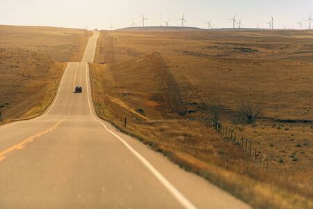 Panorama Of Colorado Eastern Plains With Freeway And Wind Mills.