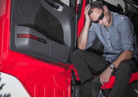 Worried Jobless Male Trucker Sitting Inside Of His Vehicle Cabin Looking Troublesome. 