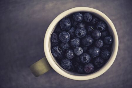 Fresh Forest Fruits. Cup Full of Blueberries Top View. Highbush Blueberry Fruit. Healthy Eating Theme.の写真素材