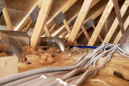 Industrial Theme. Residential Attic with Air Shafts and Electric Installations. Heating and Cooling...