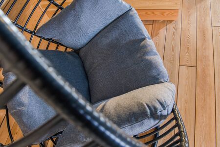 Black Oval Hanging Chair With Gray Comfortable Pillows In Residential Backyard Garden. の写真素材
