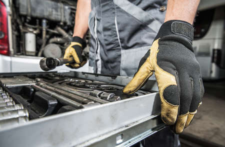 Caucasian Mechanic Selecting Right Tools For the Repair Job. Professional Garage Tools. Automotive Industry Theme.の写真素材
