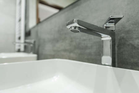 Close Up Of Silver Metal Modern Bathroom Faucet And White Porcelain Sink.の写真素材