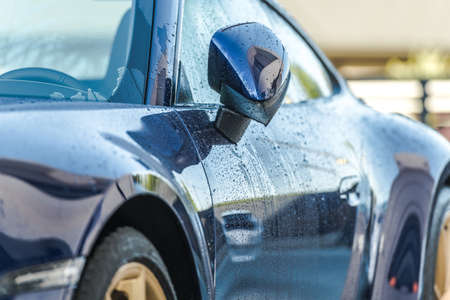 Car Wash Theme. Automotive Industry. Clean, Blue and Modern Luxury Car Right After Washing. Side...