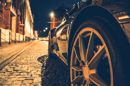 Side View of Modern Car on the City Street at Night. Automotive Night Drive Theme.の写真素材