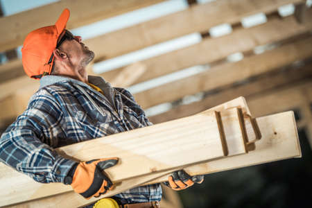 Construction Site Theme. Wooden House Structure Frame Work Job. Industrial Worker Moving Wooden...
