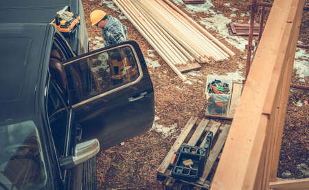 Caucasian Construction Contractor Worker in Yellow Hard Hat Preparing Himself in Front of His...