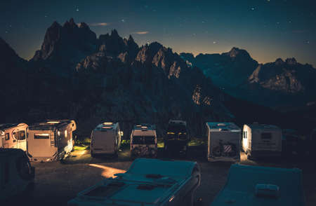Scenic Starry Sky RV Park Camping in the Dolomites. Camer Van Overnight Stay in the Mountain Scenery. Misurina Area, Italy. Recreational Vehicles Road Trip Theme.の写真素材