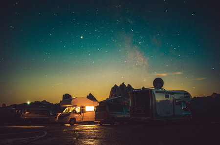 Italian Mountain RV Park Motorhome Camping Under Starry Sky. Misurina and Auronzo Di Cadore, Dolomites National Park Italy. Recreational Vehicles and Lifestyle Theme.