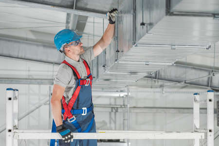 Commercial HVAC Systems Installation Inside the Warehouse Performed by Caucasian Heating and Cooling...