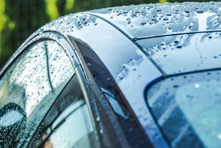 Wet Blue Car Body Right After Power Washing. Close Up Photo. Automotive Theme.の写真素材