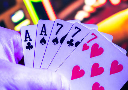 Full House in Poker Game. Gaming Cards in Gamblers Hand.