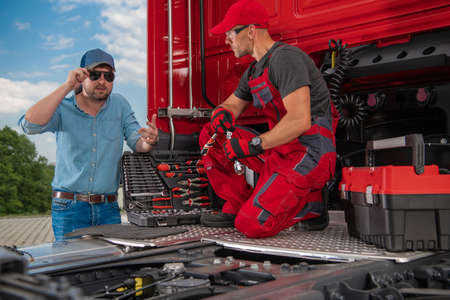 Trucker and Professional Truck Mechanic Making Conversation Regarding Semi Truck Technical Issue....