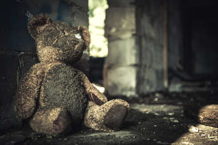 Domestic Violence or Abuse Theme with Dirty Teddy Bear Inside House Ruins.の写真素材