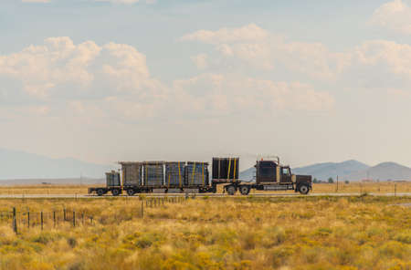 Heavy Loaded Semi Truck on a Highway Crossing Colorado Valley. United States of America Transportation Industry Theme.の写真素材