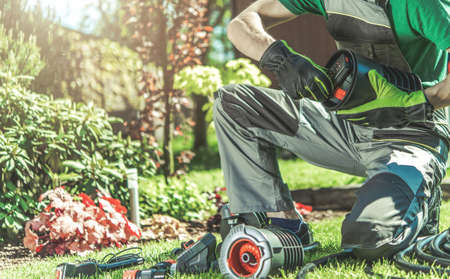 Automatic Backyard Garden Watering System Installation Performed by Professional Caucasian Garden...