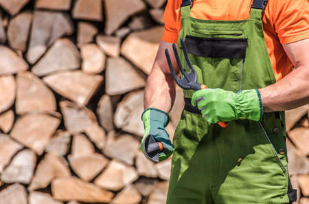 Caucasian Men in His 30s with Garden Tools in His Hands Preparing For the Job. Backyard Garden Work...