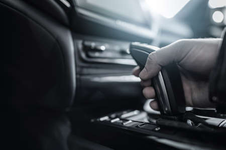 Elegant Automatic Transmission Shifter. Men Shifting Gears Inside Modern Luxury Car. Automotive...