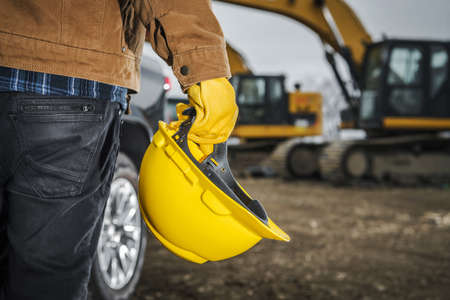 Head Safety Construction Zone. Contractor Worker with Yellow Hard in His Hand. Construction Industry...