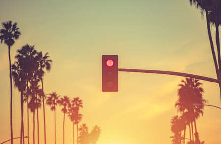 Santa Monica California Red Light and Palm Trees Conceptual Photo. United States of America. Scenic Sunset Warm Color Grading.の写真素材