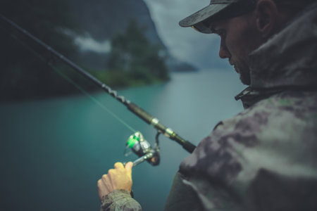 Evening Time Fly Fishing. Caucasian Fisherman with His Rod. Recreation Theme.