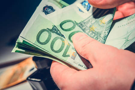 Caucasian Men Counting His Earnings in Euro Banknotes. Hands Close Up.