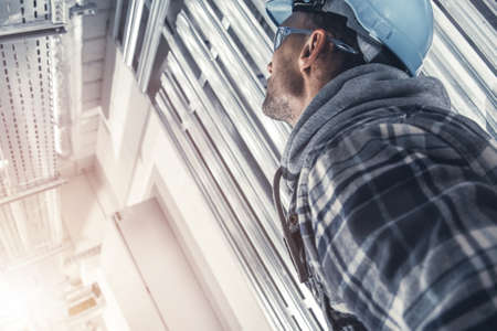 Caucasian Construction Supervisor Contractor Wearing Hard Hat and Eyes Protection Glasses Looking on...