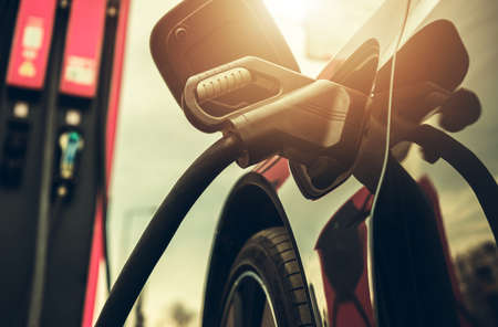Modern Electric Car Attached to High Voltage EV Station During Charging Time. Automotive Industry...