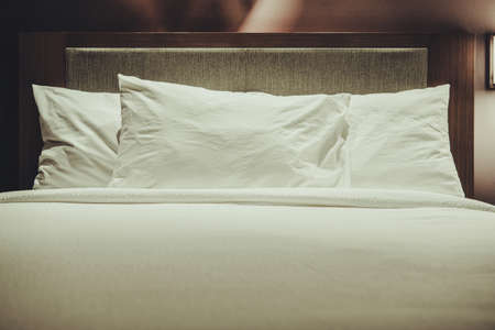 Comfortable Modern Hotel Bed with Three Pillows. Travel Industry Theme.の写真素材
