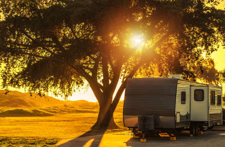 Scenic California Coastal RV Recreational Vehicles Park Travel Trailer Camping During Sunset. Rving...