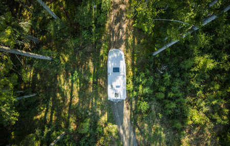 Class C Motorhome Camper Van on a Woodland Country Road Aerial View. Summer Vacation Road Trip.の写真素材