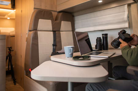 Inside the Recreational Vehicle of the Traveling Photographer. Reviewing Photos After a Day With the Camera Among Nature. Life on the Move.の写真素材