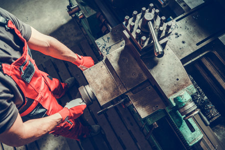 Metalworking Industry Equipment. Caucasian Metal Worker Processing Material Using Lathe
