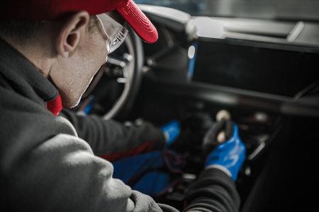 Caucasian Car Detailer Cleaning Modern Vehicle Dashboard. Automotive Industry Theme.の写真素材