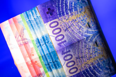 Colorful Closeup of Swiss Franc Banknotes on Blue Background. Switzerland and Liechtenstein National Currency.の写真素材