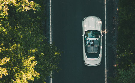 Aerial View of Man Driving His Modern White Cabriolet Along the Road. Luxury Lifestyle Theme.の写真素材