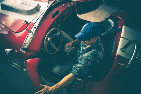 Classic Cars Restoration Theme. Professional Mechanic Inside a Classic Convertibleの写真素材