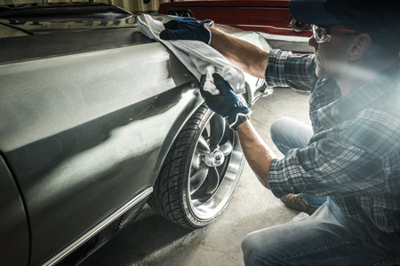 Caucasian Classic Cars Owner Cleaning His American Muscle Cars. Automotive Theme.の写真素材
