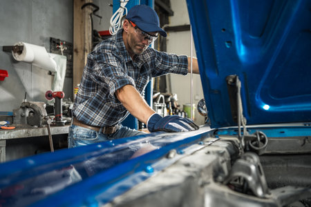 Professional Car Mechanic Taking Care of the Classic Vehicle Restoration Projectの写真素材